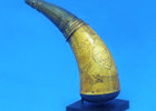 T-arm display holding small powder horn